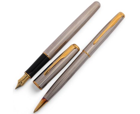 A Parker Senator/Sonnet Fountain pen with 18K nib and a matching ballpoint pen, engine turned bodies and gilt detail, both ma