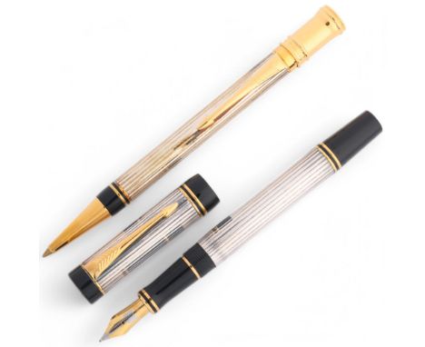 A Parker Duofold Centennial fountain pen, with white metal godron patterned body black acrylic and gilt detail, 18k gold nib 