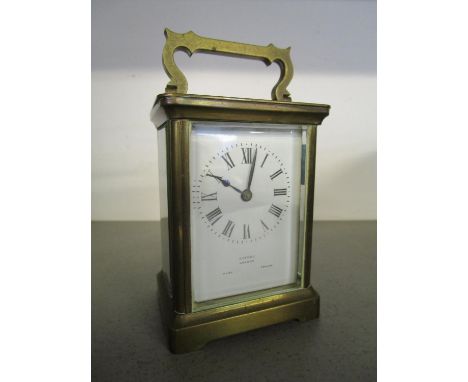 A French fire window brass cased carriage clock retailed by Asprey London, with key 