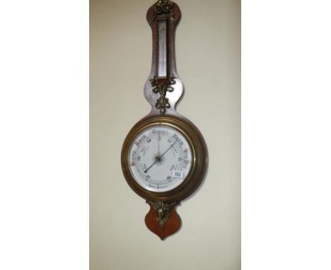 A Victorian barometer/thermometer with brass decorations,