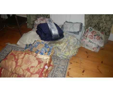 A large quantity of bedding some with matching curtains.