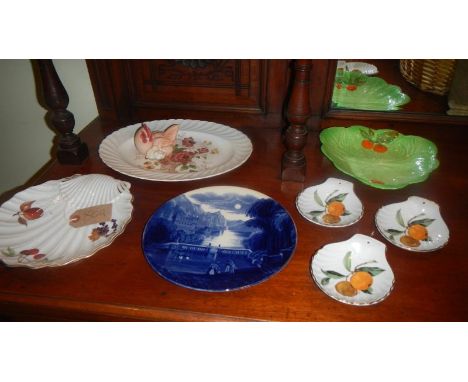 A mixed lot including Royal Worcester shell dishes, Royal Worcester men with chicks, Carlton ware dish, Clarice Cliff platter