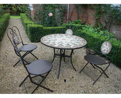 A tile topped garden table and four chairs