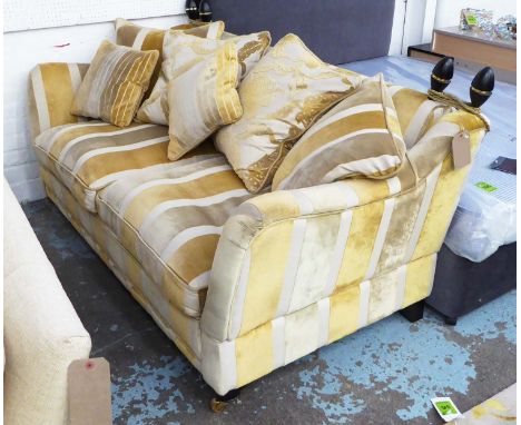 KNOLE SOFA, two seater in striped fabric, with six scatter cushions on turned castor supports, 195cm L.