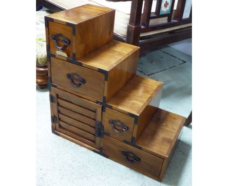 STEP TANSU, Japanese elm and iron bound containing four drawers and a door to each side, 43cm x 82cm H x 83cm. (with faults)