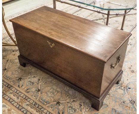 TRUNK, George III mahogany of small proportions with a rectangular rising top and brass carrying handles on bracket feet, 81c