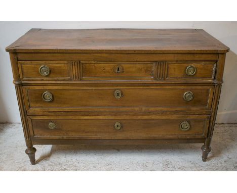 COMMODE, French Directoire, circa 1795 walnut and brass mounted with three long drawers below on short turned feet, 125cm W x