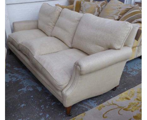 SOFA, three seater, in beige fabric on square supports with castors, 213cm L.