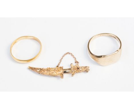 A 22ct gold ring (2.9 grams approx) and a gold ring and 9ct gold charm in the form of a dagger and scabbard (3) 