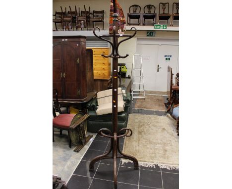 A Bentwood style beech hall stand, the upper section with coat hooks, the base with an integral stick stand