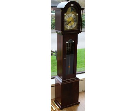 A modern grandmother clock, the dial with a silvered chapter ring, the clock with a pendulum and a triple weighted movement