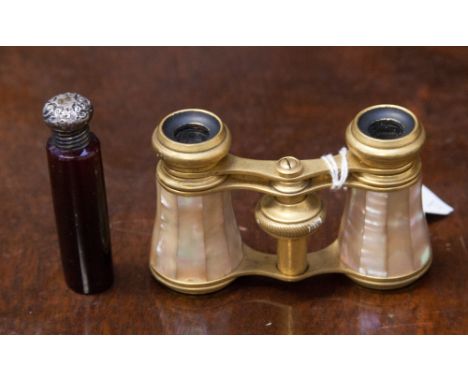 A Birmingham silver topped ruby glass scent bottle together with a mother of pearl pair of opera glasses (2) 