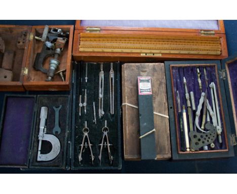 A collection of draughtsman and mechanical engineering equipment including Army and Navy rulers, compass sets, etc 
