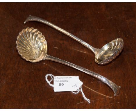 A sugar sifter, London 1899, with a matching cream ladle, both having gilt lined bowls, Onslow pattern 