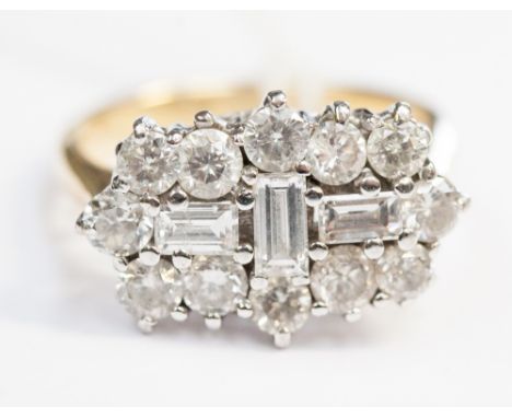 A diamond cocktail ring, the fifteen stone diamond fancy cluster comprising three baguette cuts to centre with a surround of 