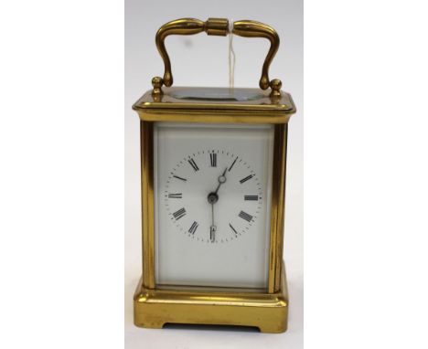 A carriage clock, bevelled glass, Roman numerals, key 