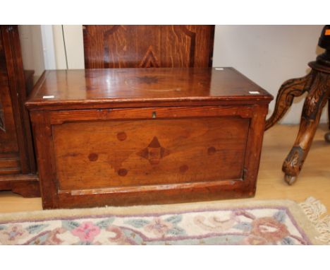 A 19th century oak and pine trunk, the top and front decoratively inlaid with mahogany veneers