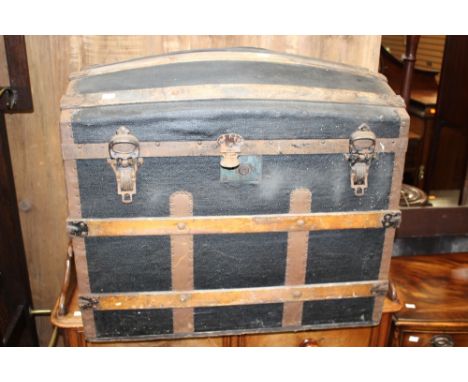 A late Victorian lidded trunk wood bound, bearing label 'William A Moore' 