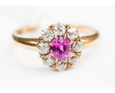 A ruby and diamond cluster ring, on 18ct gold band 