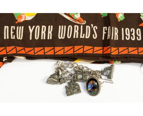 A New York World's Fair scarf, white metal charm bracelet relating to the fair and an Australian Kookaburra brooch, marked si