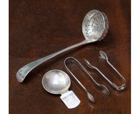 A Victorian silver sugar sifter with pierced bowl, the terminal engraved with a heraldic crest of a dragon, hallmarked for Ge