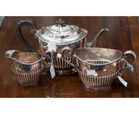 A late Victorian silver cream jug and sugar bowl of oval form, beaded rims 'S' scroll handles, reeded decoration, maker's mar