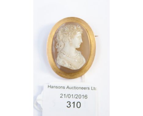 A cameo brooch, the pale carved classic features of the female bust is carved in hard paste porcelain, the necklace was once 