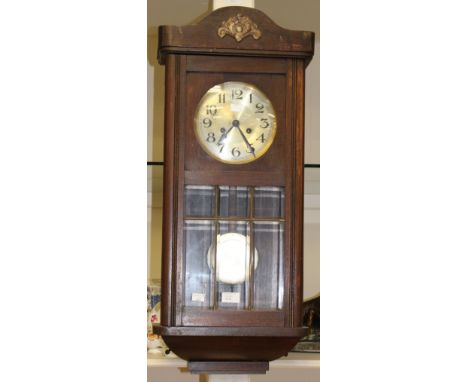 A 1930s wooden wall clock without key 