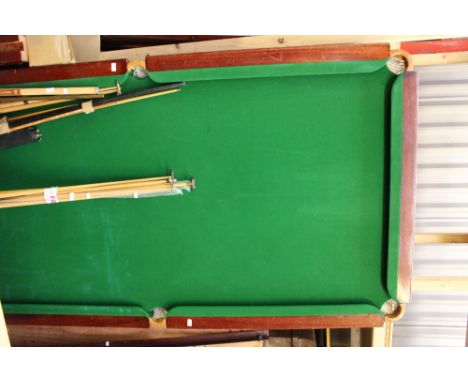 A large mahogany snooker table, with a green baized slate bed, complete with heavy turned legs, cues and accessories, (Q)
