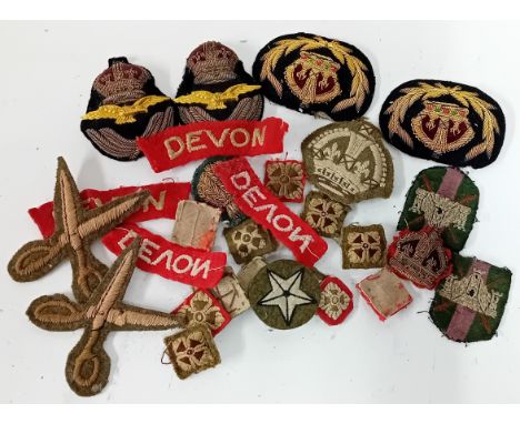 A collection of 20th century embroidered military badges, to include an RAF officer's Kings Crown cap badge, warrant officer 