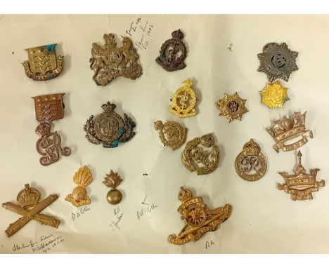 A collection of 20th century cap badges, to include a Machine Gun Corps, Ubique Fusiliers collar badge, Army Ordnance Corps, 