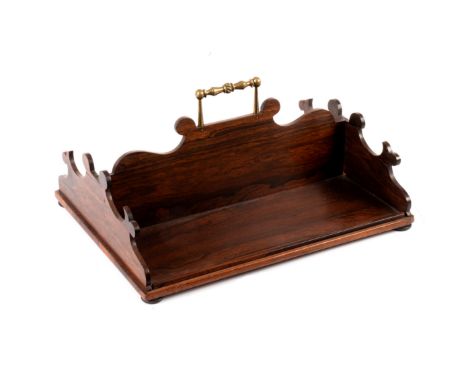 A 19th Century rosewood book trough with central brass carry handle, fret carved ends, 45.5cm wide/see illustration