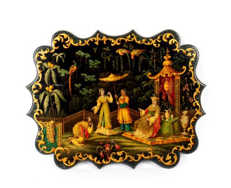 A Victorian papier-mâché panel, in the manner of Jennens &amp; Bettridge, of serpentine outline depicting a figure kneeling b