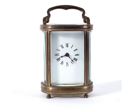 A miniature eight-day carriage clock, 10cm high, the case for the same and an oval miniature carriage clock