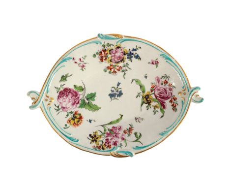 A Derby oval dish circa 1760, painted with flowers, the rims moulded as scrolls, picked out in green, 28cm diameter/see illus