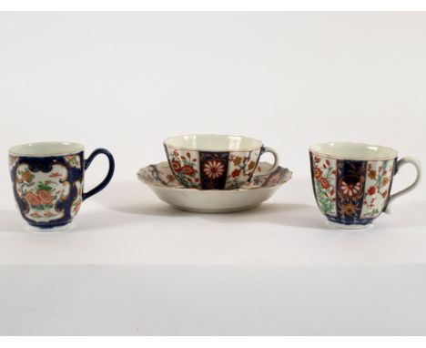 A Worcester fluted trio, circa 1770, painted with a brocade pattern of panels of Kakiemon flowers, seal marks and a coffee cu