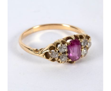 A ruby and diamond dress ring, the central oval ruby with three diamonds to each shoulder, set in yellow gold, size P