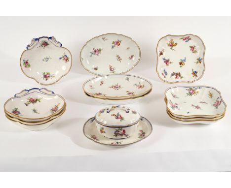 Eleven Sèvres dessert dishes and an oval sugar bowl and cover with integral stand, painted with scattered bouquets and sprigs