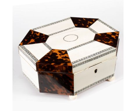 An Anglo-Indian ivory and tortoiseshell work box, the hinged cover of alternating panels, enclosing a fitted interior on bun 