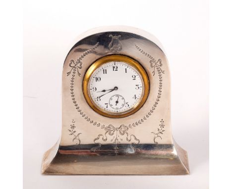 An Edwardian silver cased bedside clock, Birmingham, date marks rubbed, the white enamel dial with Arabic numerals and subsid