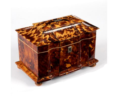A Regency tortoiseshell tea caddy of sarcophagus form with shaped front, on bun feet, 19cm wide/see illustration