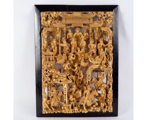 Indian School 19th Century, a gilded carved wood relief panel of figures in a temple with others ascending the building, some