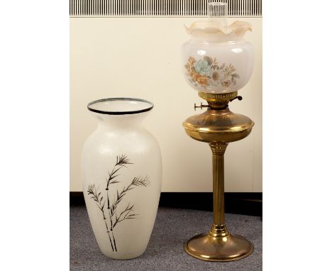 A brass oil lamp with opaque glass shade and a studio glass vase