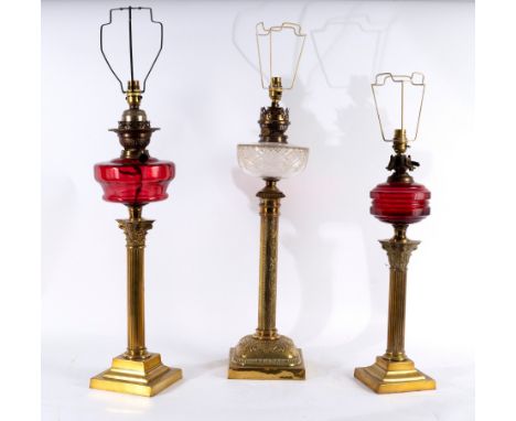 Three oil lamps, converted for electricity, each with brass column, glass reservoir and pleated shade, various sizes CONDITIO