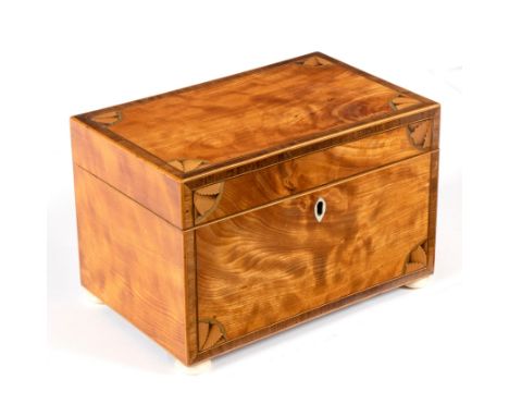 A George III satinwood tea caddy, with inlaid corner spandrels on ivory bun feet, 20cm wide CONDITION REPORT: Some staining a