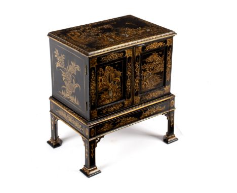 A 19th Century lacquered collector's cabinet, with chinoiserie decoration throughout, the twin panel doors enclosing seven sh