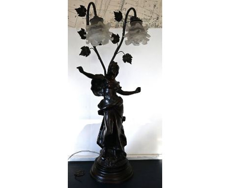 AFTER AUGUSTE MOREAU, a two&nbsp;branch table lamp, centred with a girl standing a mount holding a large book and with a two 