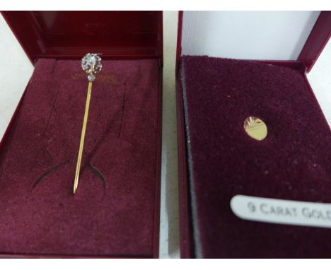 A yellow metal and diamond stick pin or tie pin together with a 9ct gold tie pin 