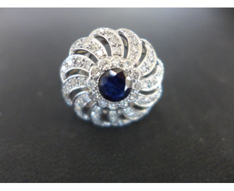 A 18ct white gold sapphire and diamond cluster ring size R - approx weight 9 grams - sapphire measures 5.5mm diameter - minor