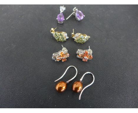 Four pairs of earrings, a pair of silver and amethyst, a pair of 9ct yellow gold green gem stone and diamond earrings, a pair